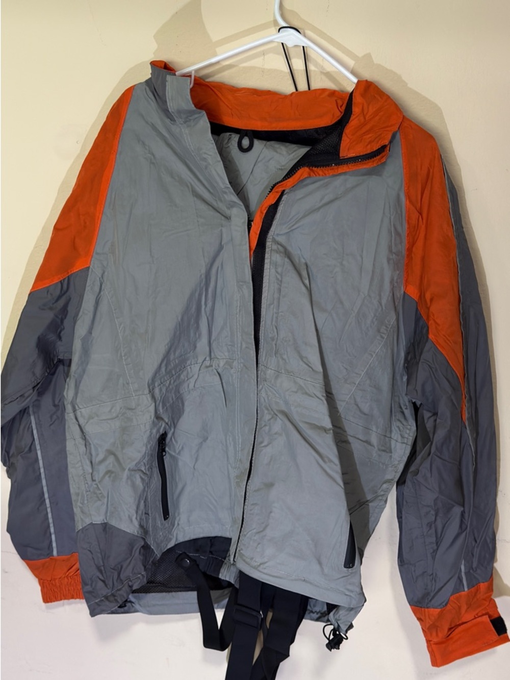 Men's lightweight Nexgen men's rain coat and pants in gray with orange accents.